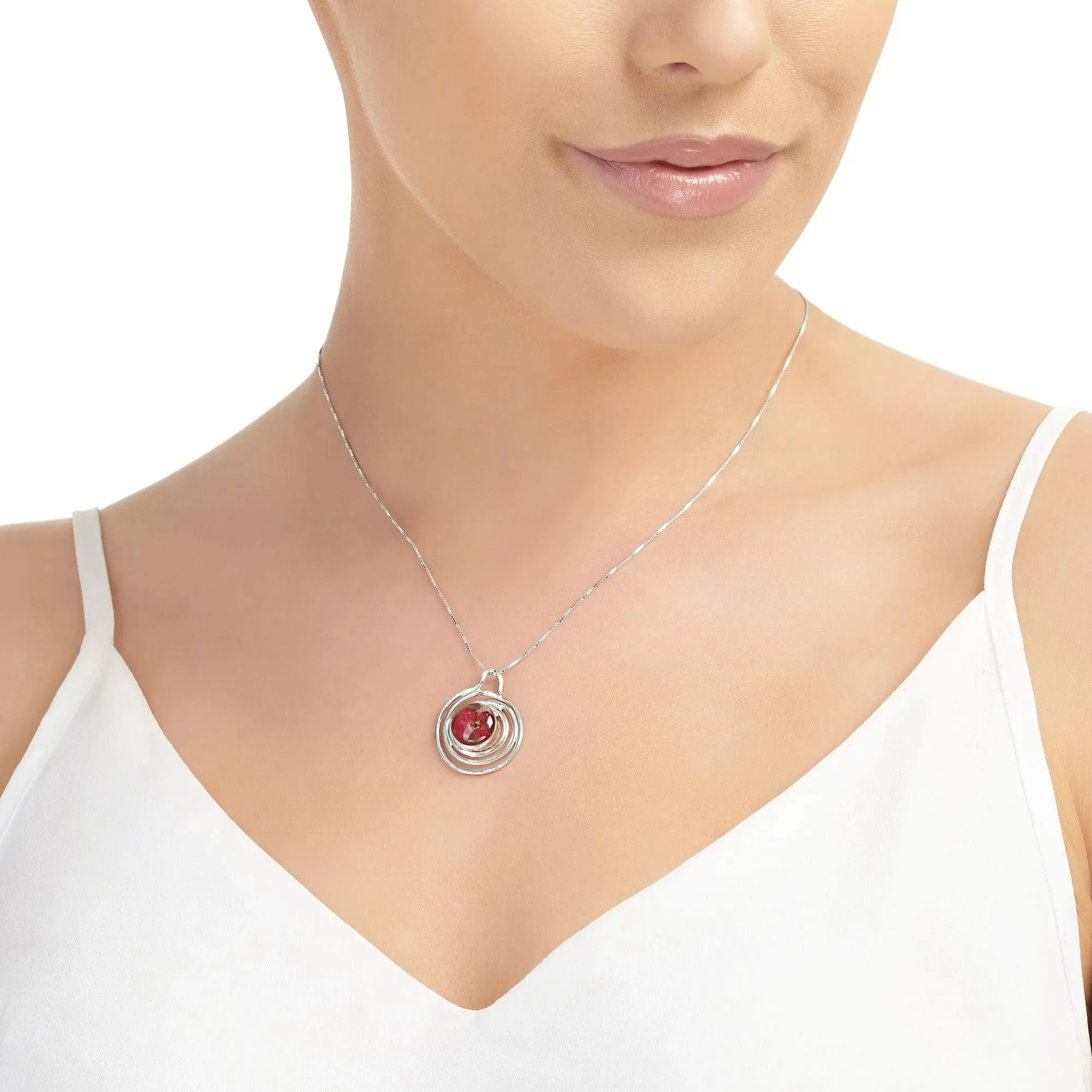 Sterling silver spiral pendant with a mini poppy (Euphorbia milii)